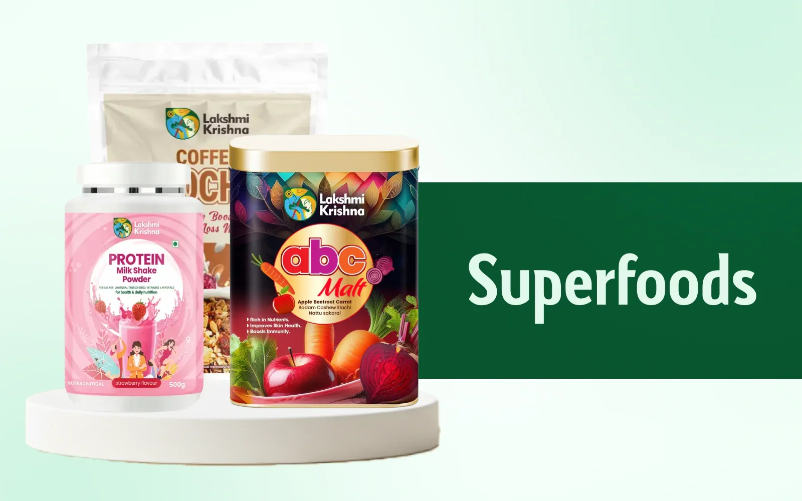 Lakshmi Krishna superfoods display featuring protein milkshake powder, ABC malt, and coffee muesli on a white platform