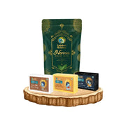 Lakshmi Krishna henna hair dye with goat milk soaps in rice, saffron, and charcoal on wooden display