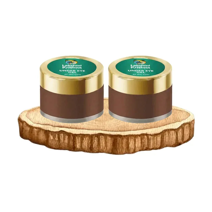 Two Kashmiri Krishna under eye gel containers with golden lids on wooden slice